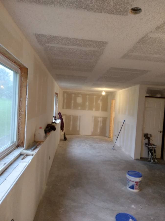 picture of a newly remodeled bathroom with gray stonework and dual luxury sinks and marble countertops